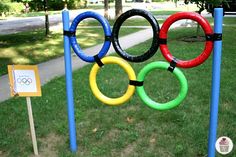 the olympic rings are on poles in front of a sign that says,'olympics '