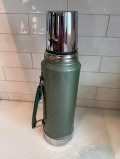 a blender sitting on top of a counter next to a white tiled backsplash