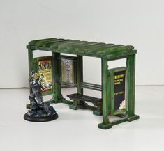 a miniature model of a man sitting on a bench