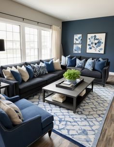 a living room filled with blue couches and pillows