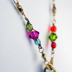 This heart hoop necklace embellished with a wide variety of multi-color Swarovski crystal and glass beads set into rainbow enamel placed on a chain beaded with Swarovski crystals and glass beads is inspired by it's own abstract and bright shape. This handmade piece is a one of a kind, fashionable statement necklace that will be perfect for any spring outfit or as a lovely gift for valentine's day. Pendant Length: 1.75 inches Pendant Width: 1.5 inches Necklace Length: 20.25 inches Additional Exte Colorful Jewelry With Adjustable Chain For Gifts, Colorful Jewelry With Adjustable Chain As Gift, Colorful Adjustable Chain Jewelry Gift, Colorful Adjustable Chain Jewelry As Gift, Rainbow Jewelry With Beaded Round Beads, Rainbow Beaded Chain Jewelry With Round Beads, Rainbow Jewelry With Round Beaded Chain, Colorful Adjustable Glass Jewelry, Handmade Colorful Glass Jewelry