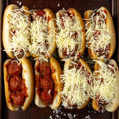 six hot dogs covered in cheese and chili