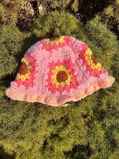 pink sunflower crochet granny square bucket hat, adult size small/ would fit best on smaller adult heads handmade in a smoke free and pet free house Handmade Yarn Bucket Hat For Spring, Handmade Pink Bohemian Bucket Hat, Handmade Bohemian Pink Bucket Hat, Pink Bohemian Flower Hat, Bohemian Pink Flower Hat, Whimsical Pink Handmade Crochet Hat, Whimsical Handmade Pink Crochet Hat, Handmade Yellow Bucket Hat For Spring, Pink Crochet Bucket Hat For Festivals