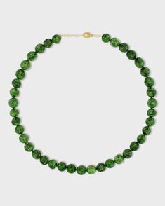 This elegant necklace features a polished chrome diopside sphere finished with a delicate 14k gold chain. Chrome diopside is a beautiful gemstone known for its vibrant green color. The smooth, polished sphere adds a touch of sophistication to the piece. This necklace is handcrafted in NYC and is a perfect everyday piece that adds a touch of natural beauty to any outfit. Chrome Diopside 14 Karat Gold 16 to 17.5 inches Handmade in NYC Chrome Diopside Jewelry, Classic Green Gemstone Beads Necklace, Formal Green Necklace With Gemstone Beads, Green Gemstone Bead Necklaces, Elegant Dark Green Round Beads Necklace, Elegant Dark Green Round Bead Necklaces, Elegant Dark Green Round Beaded Necklaces, Elegant Dark Green Beaded Necklaces, Sphere Necklace