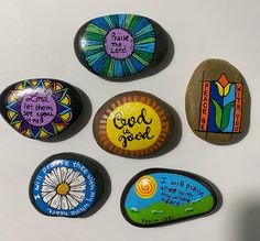 six painted rocks with words and pictures on them