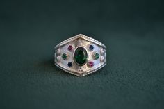 Another byzantine ring with multiple stones on it, that is entirely made with solid Sterling Silver (925 silver). In the center of the ring, a beautiful oval CZ Emerald, and around it 6 round cz stones (Emerald, Ruby, Sapphire). Byzantine Ring, Byzantine Rings, Greek Ring, Artisan Rings, Greek Jewelry, Ruby Sapphire, 925 Silver Ring, Multi Stone Ring, Cz Stone