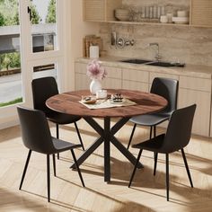 a kitchen table with four chairs around it