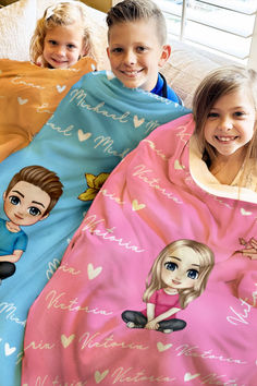 three children wrapped in blankets on a bed