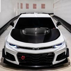 the front end of a white chevrolet camaro