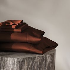 a stack of brown sheets sitting on top of a wooden table