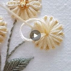 the video shows how to make crochet flowers with yarn and beads, as well as knitting needles