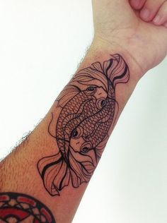 a hand with a fish tattoo on it