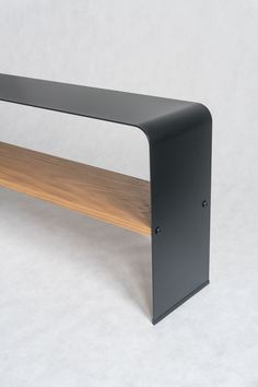 a wooden and metal shelf sitting on top of a white floor