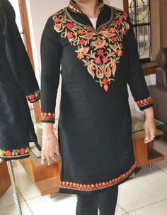 Grace any occasion with this casual and traditional jacket and step out of the crowd, Wear it with a pair of jeans, or any complementing outfit.  A perfect combination of style and tradition, A coat for cool summer nights to cold winter days. One of a kind as this coat is not mass-produced. Kashmiri coats are hand Embroidered and machine stitched by artisans over long winters in the Himalayas mountains. Material : 100% Pure Wool Coat Length: 100 cm or 37-39 inch Chest / Bust: 115 cm or 39-41+ inch circumference Shoulder Width: 47 cm or 19inch Sleeves Length: 50 cm or 19-21 inch Crafted from Raw wool with the traditional Ari thread work of Kashmir.  Kashmiri Aari hooks technique uses pointed crochet on  wool fabric. A combination of vibrant shades with a beautiful play of colors. The front Traditional Jacket, Boho Jacket, Long Winter, Embroidered Jacket, Wool Fabric, Long Coat, Wool Coat, Aza Fashion, Hand Embroidered