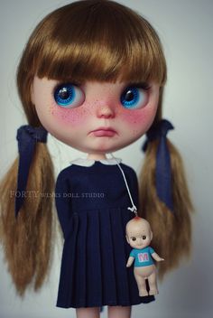 a close up of a doll with blue eyes