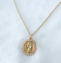 Our lady of Guadalupe necklace MATERIAL AND SIZE 18k gold plated medal 18k gold filled cable chain  Cubic zirconia  Size pendant: 2cmx1cm Length chain: 45cm If you have questions about the product, feel free to reach me out. Don't forget to check out my other items in the store: Https://www.etsy.com/shop/nyahwithlove Gold Virgencita Necklace, Spiritual Miraculous Medal Pendant Jewelry, Spiritual Miraculous Medal Oval Pendant Jewelry, Spiritual Oval Pendant Jewelry With Miraculous Medal, Spiritual Our Lady Of Guadalupe Pendant Necklace, Spiritual Our Lady Of Guadalupe Jewelry Gift, Spiritual Virgin Mary Medallion Jewelry, Spiritual Jewelry: Our Lady Of Guadalupe Round Pendant, Silver Our Lady Of Guadalupe Necklace