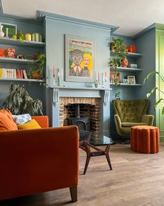 a living room filled with furniture and a fire place under a painting on the wall