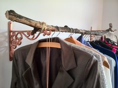 a coat rack with clothes hanging on it