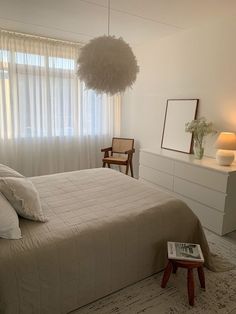 a bedroom with a large bed and white curtains