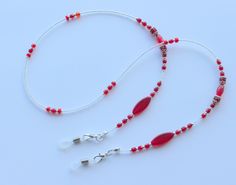 "Beautiful glasses chain made using vintage red glass beads and tiny glass seed beads.  The chain measures approximately 28\" in length and is finished with rubber glasses ends to securely attach your glasses to. Wrapped in tissue paper and presented in an organza pouch." Adjustable Red Necklaces With Oval Beads, Adjustable Red Necklace With Oval Beads, Adjustable Red Glass Necklace, Red Beaded Chain Jewelry For Festival, Red Glass Glasses Chains As A Gift, Red Glass Jewelry With Adjustable Chain, Red Glass Glasses Chains For Gift, Red Beaded Glass Jewelry, Red Glass Jewelry For Festivals