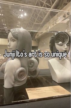 two mannequins sitting on top of a table next to each other with the words, juri it's art is so unique