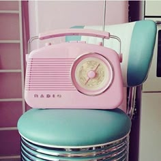 a pink radio sitting on top of a blue chair