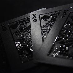 three playing cards are shown in black and white