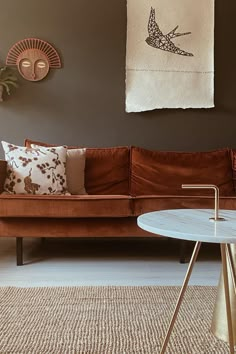 a living room with a brown couch and table