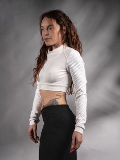 White cyberpunk crop top with long sleeves. Edgy and unique design inspired by Sci Fi.  KEY FEATURES - Special neckline - for an edgy look; - Made with special stretchy threads - Qualitative dense jersey fabric. - Labels are sewn on separately so you can remove them without damaging the garment. SIZE & MEASUREMENTS All sizes are given in the last picture. The fabric is stretchy. If you aren't sure about the size, add your bust, waist, hips, and height measurements as a note. FABRIC: White textur White Stretch Edgy Crop Top, Edgy White Stretch Crop Top, Edgy Stretch Crop Top For Alternative Fashion, Punk Style Long Sleeve Stretch Crop Top, Stretch Punk Crop Top For Streetwear, White Fitted Edgy Crop Top, Edgy White Fitted Crop Top, Fitted Crop Top For Club In Winter, Fitted Winter Crop Top For Club