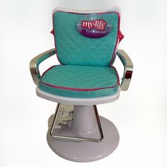 a blue and white chair sitting on top of a metal base with a red trim around the armrest