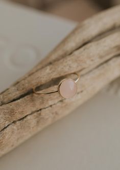 Our Rosie ring is made with a stunning Rose Quartz stone. Known as the crystal of unconditional love, it's said to boost feelings of self-love and foster loving relationships with others. It’s a crystal connected to the heart chakra which colors our life with compassion, love and beauty. 8mm round or 6x8mm round rose quartz stone. Ring band measures 1mm wide. Available in 14kt Gold Fill + Sterling Silver. Rediert pairs it with our Supermoon Ring and Teeny-Tiny Band. Kayla pairs it with two Confe 14k Gold Filled Gemstone Rings For Gift, Round Rose Quartz Promise Ring, Rose Gold Rose Quartz Promise Ring, Everyday Rose Gold Gemstone Rings, Adjustable Rose Quartz Ring, Rose Quartz Crystal Promise Ring, Delicate Rose Gold Crystal Ring, Rose Gold Rings With Rose Quartz For Gifts, Round Rose Quartz Birthstone Jewelry