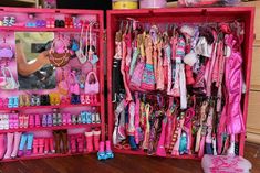 a pink box filled with lots of barbie dolls and accessories