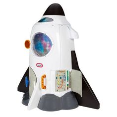 a white and black toy rocket ship sitting on top of a table