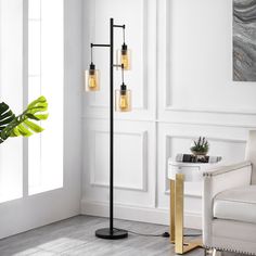 This 3-light tree floor lamp features clean lines and a simple, minimalist design that complements your industrial and farmhouse decor in the living room or bedroom. It has a 65" tall frame that's made from metal with a sleek matte black finish, and it stands on a rounded base. The clear cylindrical glass shades showcase an open bulb base that each accommodates a bulb up to 60 W (not included). Plus, this floor lamp has a foot switch on the base that makes it easy to turn the light on and off. GETLEDEL 65-in Black Multi-head Floor Lamp | PT-050700 Pc Ideas, Lamp With Glass, Farmhouse Room, Tree Floor Lamp, Unique Floor Lamps, Chicago Apartment, Office Lamp, Apt Decor, Nyc Apt