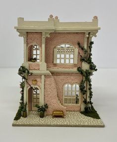 a doll house with ivy growing all over it's walls and windows on the outside