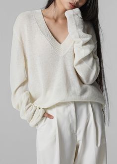 Color: Cream Lightweight wool blend fabric Regular fit Deep v neck Drop shoulders Rib knit trim Slip on style Unlined 35% Polyamide 30% Wool 25% Alpaca 10% Acrylic Dry Clean Imported