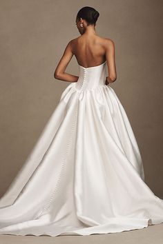 a woman in a white wedding dress is looking back