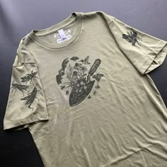 100% Organic Cotton Unisex T-shirt hand printed with an original illustration of a trowel and many pollinators often overlooked.  Plus - Grasshopper sleeves  Unisex, made for everyone. click on size chart to expand if it appears cropped! Printed Tshirts, Block Print T Shirt, Goblincore Cotton Streetwear Tops, Garden T Shirt, Summer Goblincore Short Sleeve T-shirt, Green Cotton Nature-inspired T-shirt, Goblincore Graphic Print Short Sleeve T-shirt, Hand Printed Shirt, Vintage Cotton T-shirt With Mushroom Print