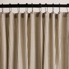 a striped curtain hanging from a metal rod