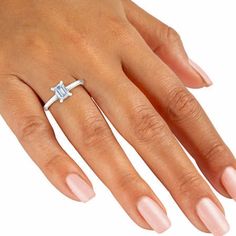 a woman's hand with a diamond ring on it