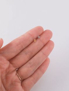 Tiny open circle stud earrings - super cute and very versatile, you can pair it with any other earrings or jewelry. D E T A I L S * Circle is 3 mm, 20 gauge post * Butterfly back included * 18k gold over sterling silver // white gold over sterling silver * Nickel free and hypoallergenic S H O W   U S   S O M E  ♥ Instagram: @Minthologie Facebook: facebook.com/Minthologie Internally Threaded Small Hoop Earrings As Gift, Dainty Internally Threaded Round Earrings, Dainty Round Internally Threaded Earrings, Dainty Circle Earrings For Pierced Ears, Dainty Circular Earrings, Dainty 14k Gold Circle Earrings, Dainty Round Pierced Plug Earrings, Open Circle Stud Earrings, Elegant Gold Semi-circle Earrings