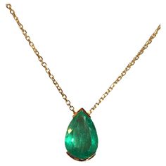 Natural Fine Colombian Emerald Pear Drop Pendant, crafted in an 18 Karat Gold bezel setting – designed to show the spectacular brilliance and beautiful medium green color and excellent transparency of this magnificent gemstone. - Natural Colombian Emerald 3.00 Carats. - Set in 18 Karat Gold. - Length 15.00mm Width 8.00 mm Depth 5.79 mm. - Suspended on 18 Karat Gold chain, 18 inches in length. Luxury Pear-shaped Emerald Gemstone Necklace, Pear-shaped Emerald Gemstone Necklace For Formal Events, Pear-shaped Emerald Gemstone Necklace For Formal Occasions, Exquisite Pear-shaped Emerald Necklace For Formal Occasions, Luxury Teardrop Emerald Necklace With 17 Jewels, Formal Pear-shaped Emerald Necklace In Fine Jewelry Style, Formal Pear-shaped Emerald Necklace Fine Jewelry, Formal Pear-shaped Emerald Necklace, Luxury Yellow Gold Emerald Necklace With Prong Setting