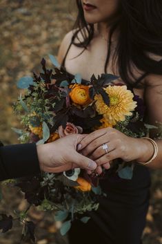 two people holding flowers in their hands