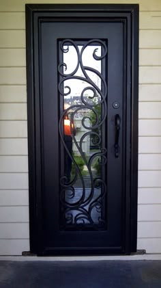 a black door with an iron design on it