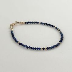 Elevate your style with this royal blue Lapis Lazuli Bracelet, a dainty gemstone beaded jewelry piece that's as elegant as it is versatile. This skinny blue stone bracelet is not only a stunning accessory but also serves as a meaningful September birthstone gift, making it a perfect choice for a birthday celebration or a memorable 9th anniversary gift for women, mom, girlfriend, teacher, sister, bridesmaid or bride. With its deep blue hues and natural beauty, this Lapis Lazuli bracelet is sure t Sapphire Beaded Jewelry Gift, Adjustable Faceted Sapphire Bracelets, Sapphire Beaded Jewelry For Gifts, Adjustable Faceted Sapphire Bracelet, Dainty Blue Bracelets With Faceted Beads, Blue Birthstone Round Bead Bracelets, Faceted Sapphire Beaded Bracelets As Gift, Blue Birthstone Bracelets With Round Beads, Adjustable Sapphire Beaded Bracelets As Gift