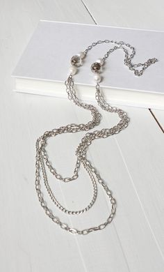 Long layered chains necklace sparkly glass beads and white freshwater pearls Multi-strand Pearl Beaded Necklaces, Multi-strand Pearl Beaded Chain Jewelry, Multi-strand Pearl Beaded Necklace, Silver Multi-strand Pearl Necklace, Silver Necklaces With Beaded Chain For Layering, Silver Pearl Necklace With Double Chain, Silver Double Strand Pearl Beaded Necklaces, White Metal Layered Necklace With Chain Detail, Metal Jewelry With Beaded Chain For Layering