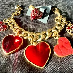 Pilgrim Skanderborg Gold Tone Link Brass Bracelet With Red Leatherette, Swarovski Red Crystals And Resin Heart Charm Bracelet, With Matching Swarovski Red Crystal Heart Ring, Adjustable. Valentine's Day Costume Jewelry In Metal, Valentine's Day Metal Costume Jewelry, Elegant Valentine's Day Jewelry, Heart-shaped Bracelet For Valentine's Day Party, Heart Bracelet For Valentine's Day Party, Valentine's Day Heart Bracelet For Party, Valentine's Day Party Charms For Jewelry, Valentine's Day Party Jewelry With Charms, Valentine's Day Party Charms Jewelry