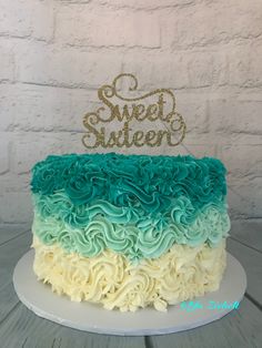 a cake that is sitting on top of a table with the words sweet sixteen spelled in gold