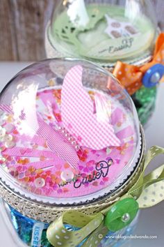 two glass jars filled with different types of candies