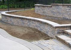 an outdoor patio with steps and retaining wall